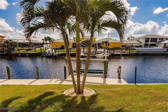 dock area featuring a yard and a water view