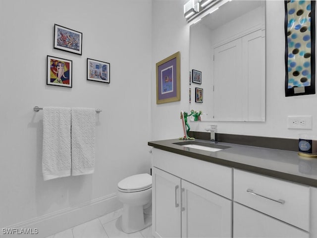 bathroom featuring tile patterned flooring, vanity, and toilet