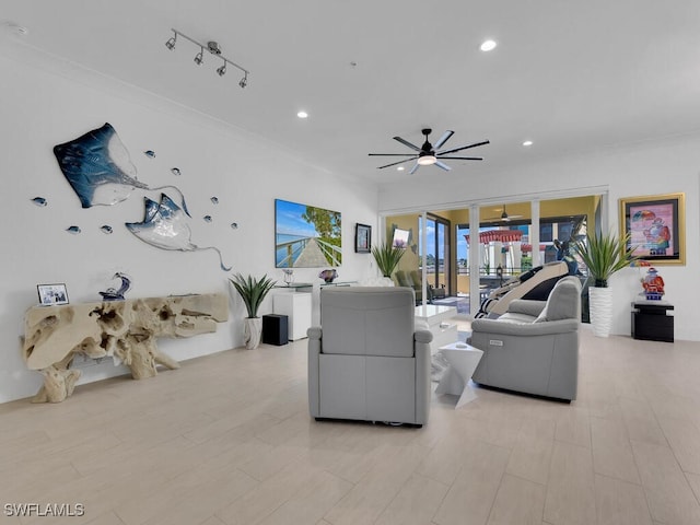 living room featuring ceiling fan, rail lighting, and ornamental molding