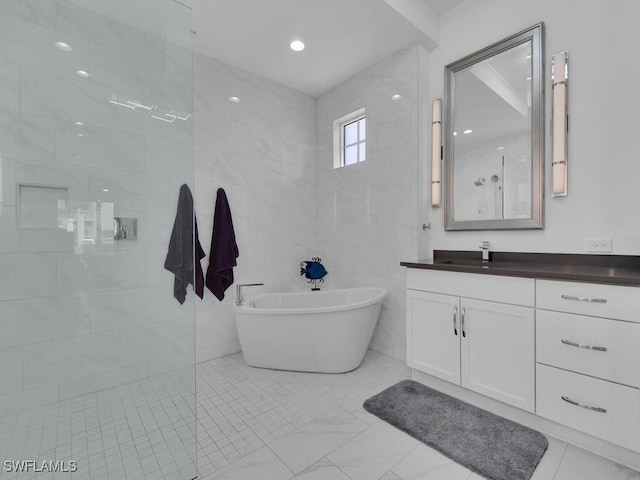 bathroom featuring vanity, tile walls, and independent shower and bath