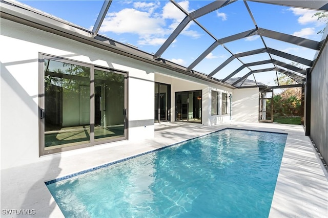 view of swimming pool featuring a patio and a lanai