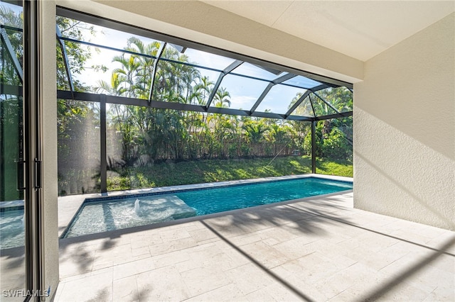 view of swimming pool featuring a lanai and a patio