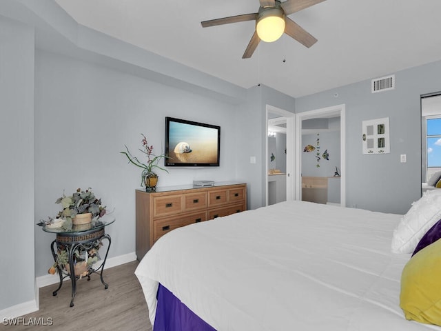 bedroom featuring connected bathroom, ceiling fan, and light wood-type flooring