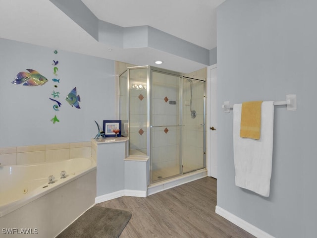 bathroom with plus walk in shower and hardwood / wood-style floors