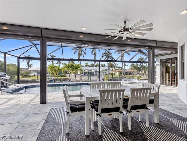 view of patio / terrace featuring a lanai, grilling area, and ceiling fan