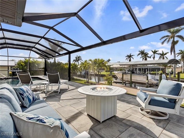 view of patio featuring glass enclosure and an outdoor fire pit