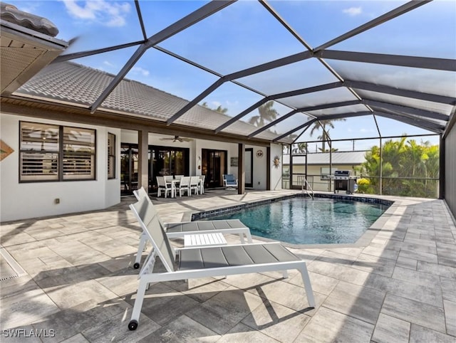 view of pool featuring ceiling fan, a lanai, and a patio