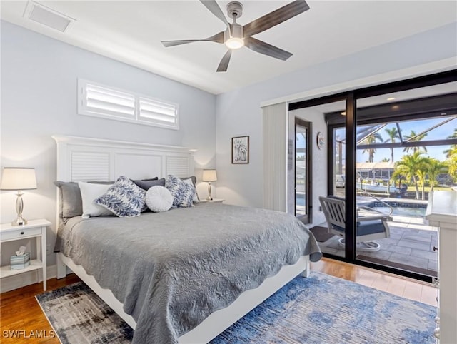 bedroom with ceiling fan, access to exterior, and wood-type flooring