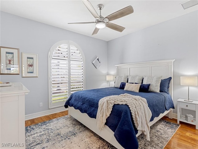 bedroom with light hardwood / wood-style floors and ceiling fan