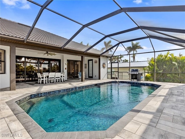 view of pool featuring ceiling fan, a patio area, a lanai, and area for grilling