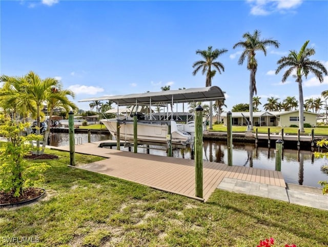 view of dock with a yard and a water view