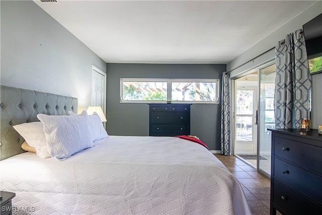 tiled bedroom with access to outside and multiple windows