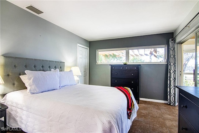 tiled bedroom featuring multiple windows