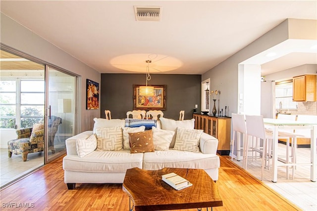 living room with plenty of natural light and light wood-type flooring