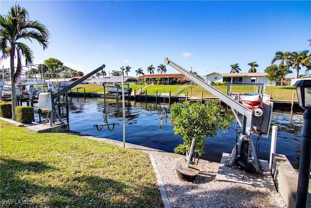 dock area with a yard and a water view