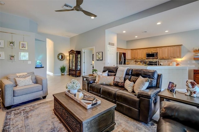 tiled living room with ceiling fan