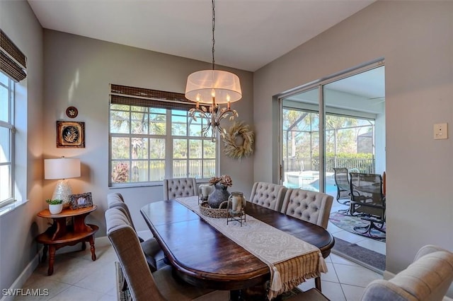 dining space with light tile patterned floors and a notable chandelier