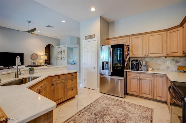 kitchen with ceiling fan, sink, black / electric stove, stainless steel fridge, and light tile patterned flooring