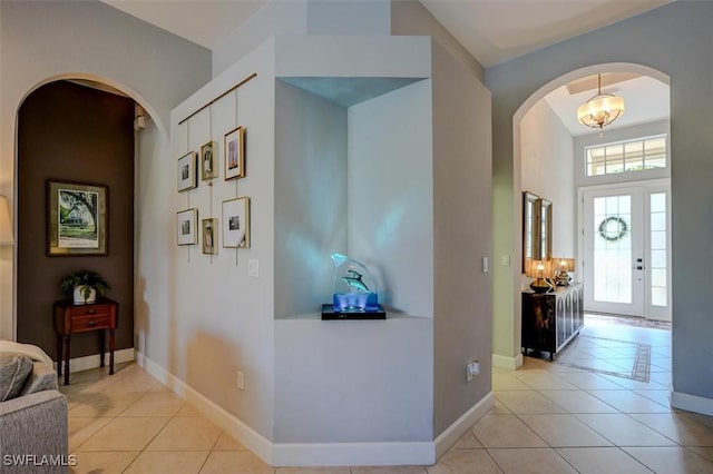 hall featuring light tile patterned floors