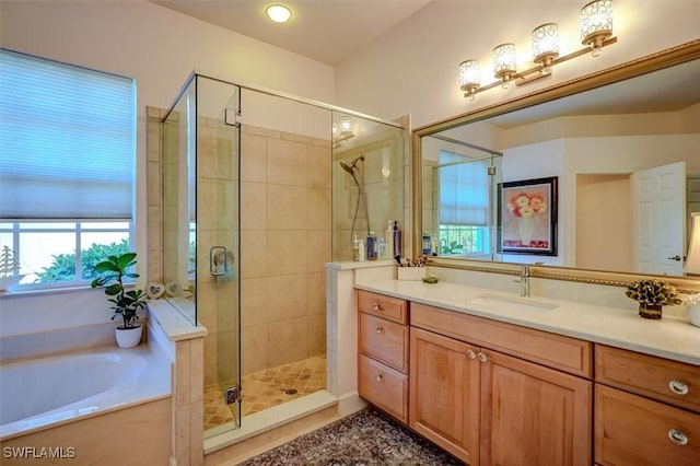 bathroom with vanity and independent shower and bath