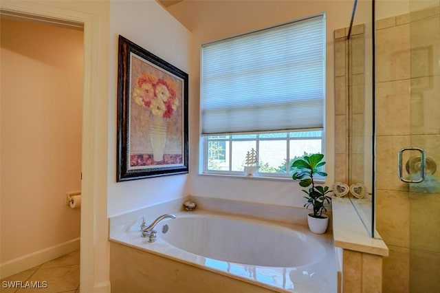 bathroom with separate shower and tub and tile patterned flooring