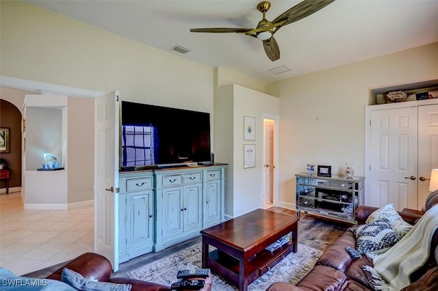 tiled living room with ceiling fan