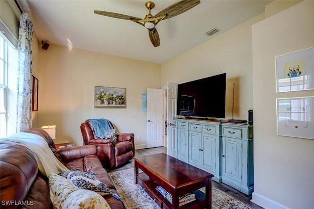 living room with hardwood / wood-style floors and ceiling fan