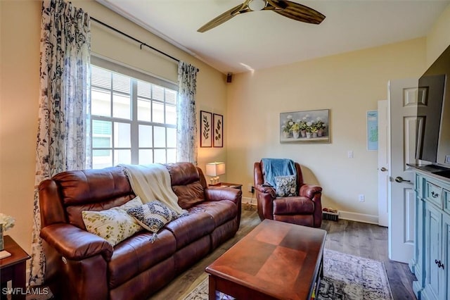 living room with hardwood / wood-style floors and ceiling fan