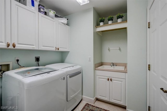 clothes washing area featuring light tile patterned flooring, cabinets, independent washer and dryer, and sink