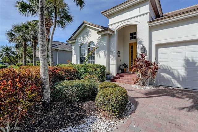 view of exterior entry featuring a garage