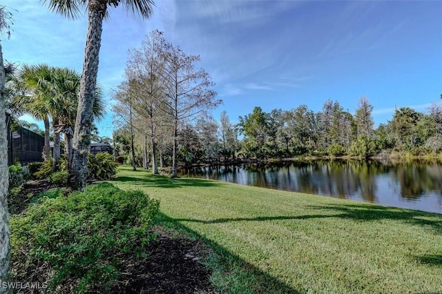 view of community with a yard and a water view