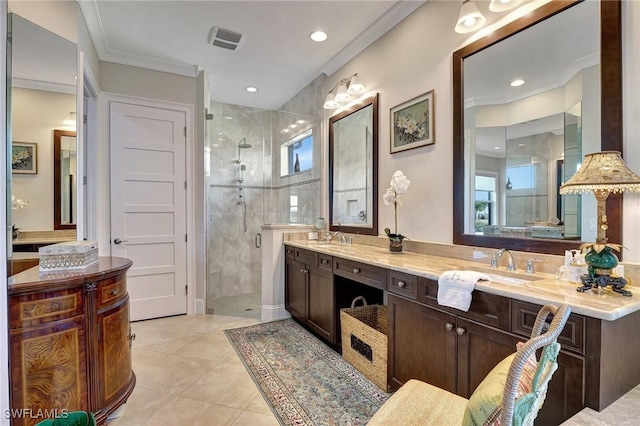 bathroom featuring tile patterned flooring, vanity, a shower with door, and ornamental molding