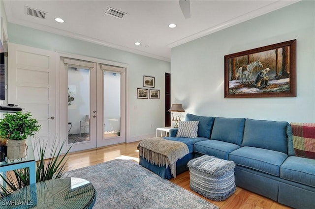 living room with french doors, ornamental molding, and hardwood / wood-style floors