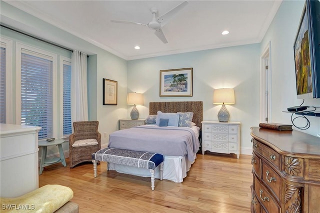 bedroom featuring ceiling fan, light hardwood / wood-style floors, and crown molding