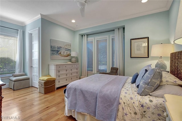 bedroom featuring light hardwood / wood-style floors, ceiling fan, and crown molding