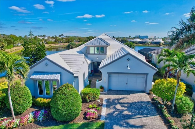 view of front of home featuring a garage and a water view