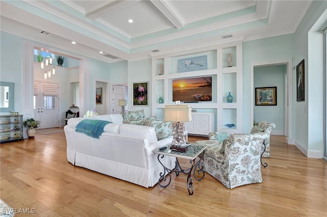 living room featuring a high ceiling, built in shelves, ornamental molding, beamed ceiling, and light hardwood / wood-style floors