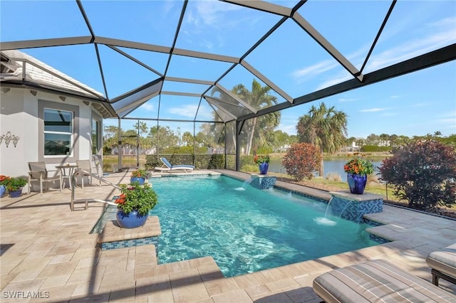 view of pool featuring glass enclosure, pool water feature, a water view, and a patio