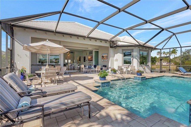 view of pool with glass enclosure and a patio area