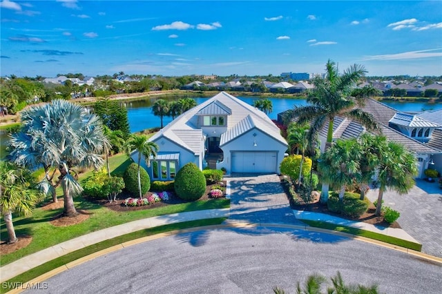 view of front of property with a water view and a garage