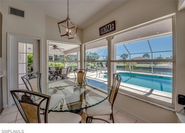 sunroom featuring a chandelier