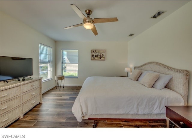 bedroom with ceiling fan and dark wood-type flooring