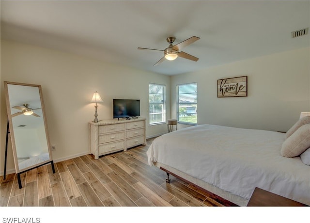 bedroom with ceiling fan and light wood-type flooring