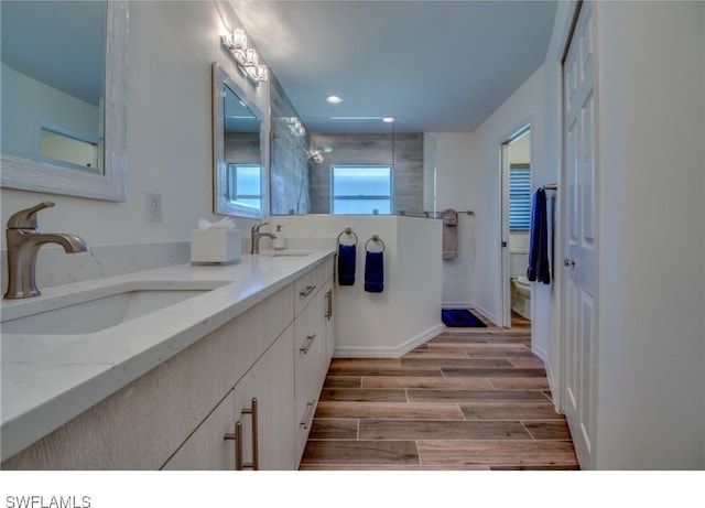 bathroom featuring vanity, toilet, and walk in shower