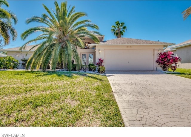 view of front of home with a garage, a front yard, and french doors