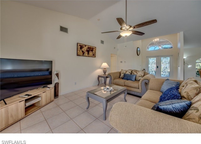 tiled living room featuring ceiling fan, french doors, and high vaulted ceiling