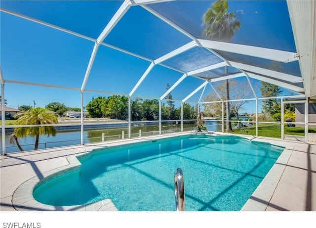 view of swimming pool with glass enclosure, a water view, and a patio