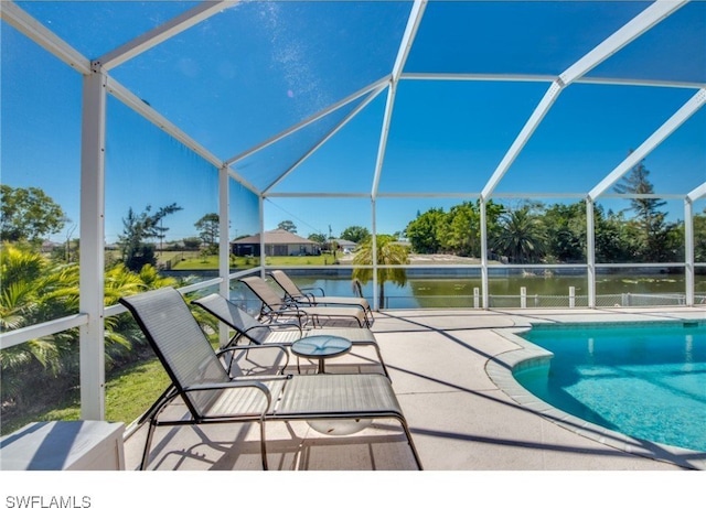 view of swimming pool with a lanai, a patio area, and a water view