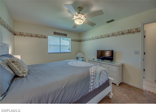 tiled bedroom featuring ceiling fan