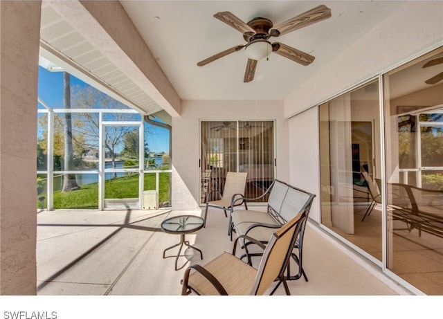 sunroom / solarium featuring ceiling fan